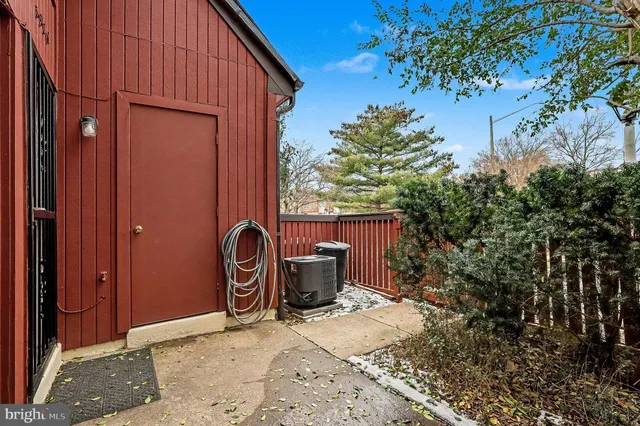 a backyard of a house with barbeque oven fire pit table and chairs