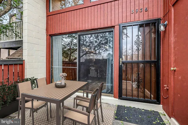 a view of a patio with a table and chairs