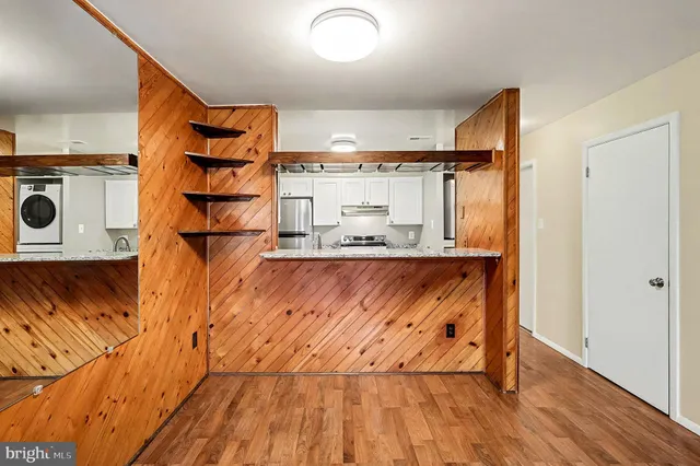 a view of a kitchen with wooden floor and a sink
