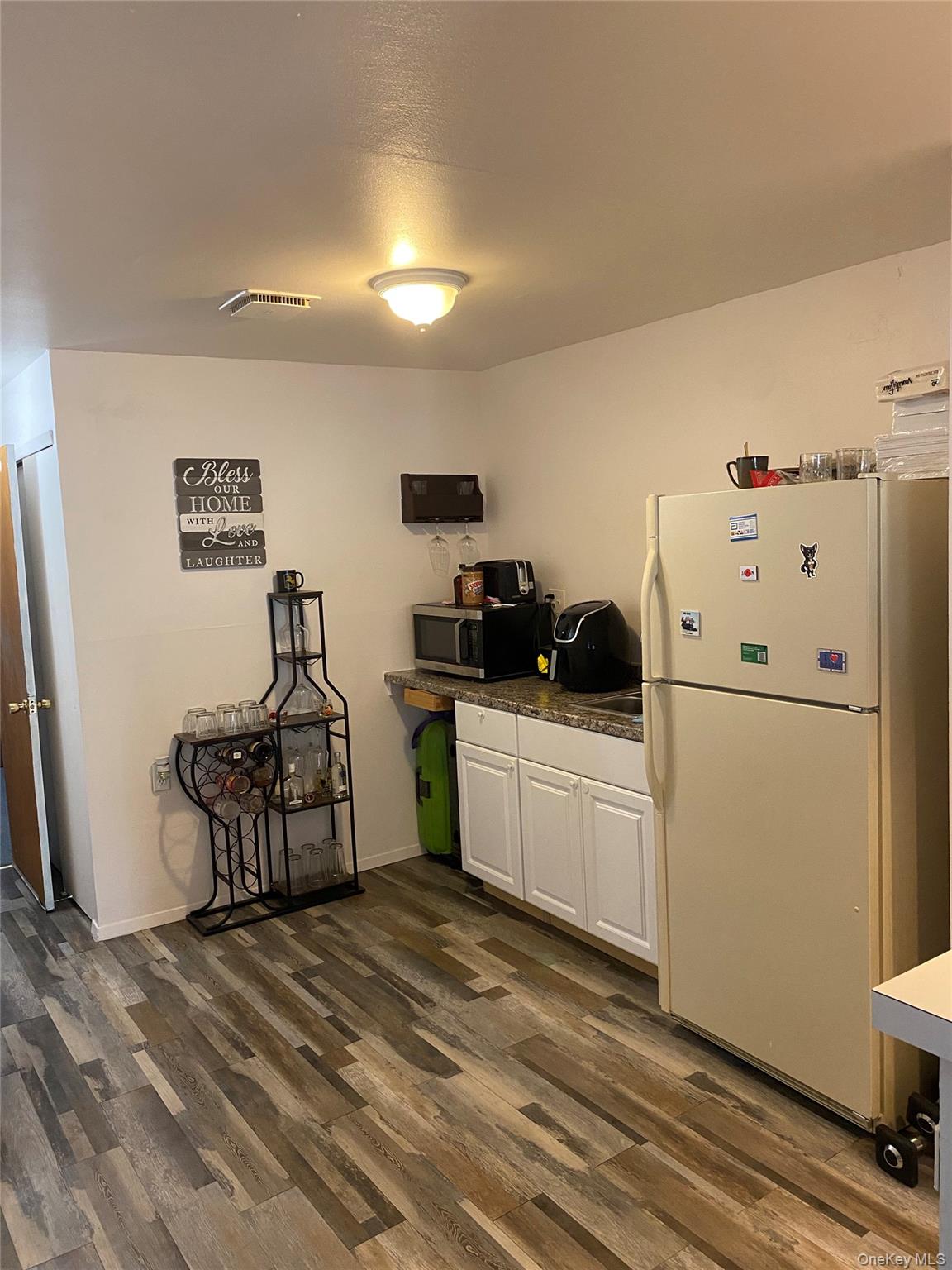 84-24 98th Street, Unit 1 Queens, NY 11421 - Photo 18 of 22 a kitchen with a refrigerator a sink and a stove top oven