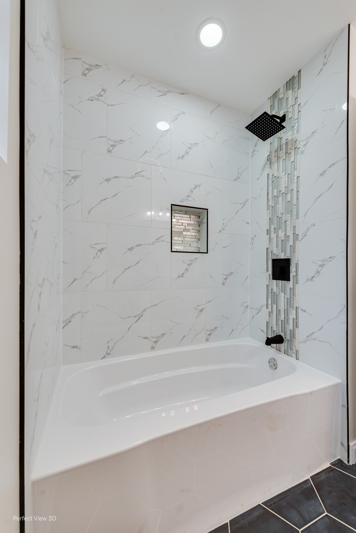 1319 East 89th Street Chicago, IL 60619 - Photo 5 of 17 a bathroom with a bathtub and a shower