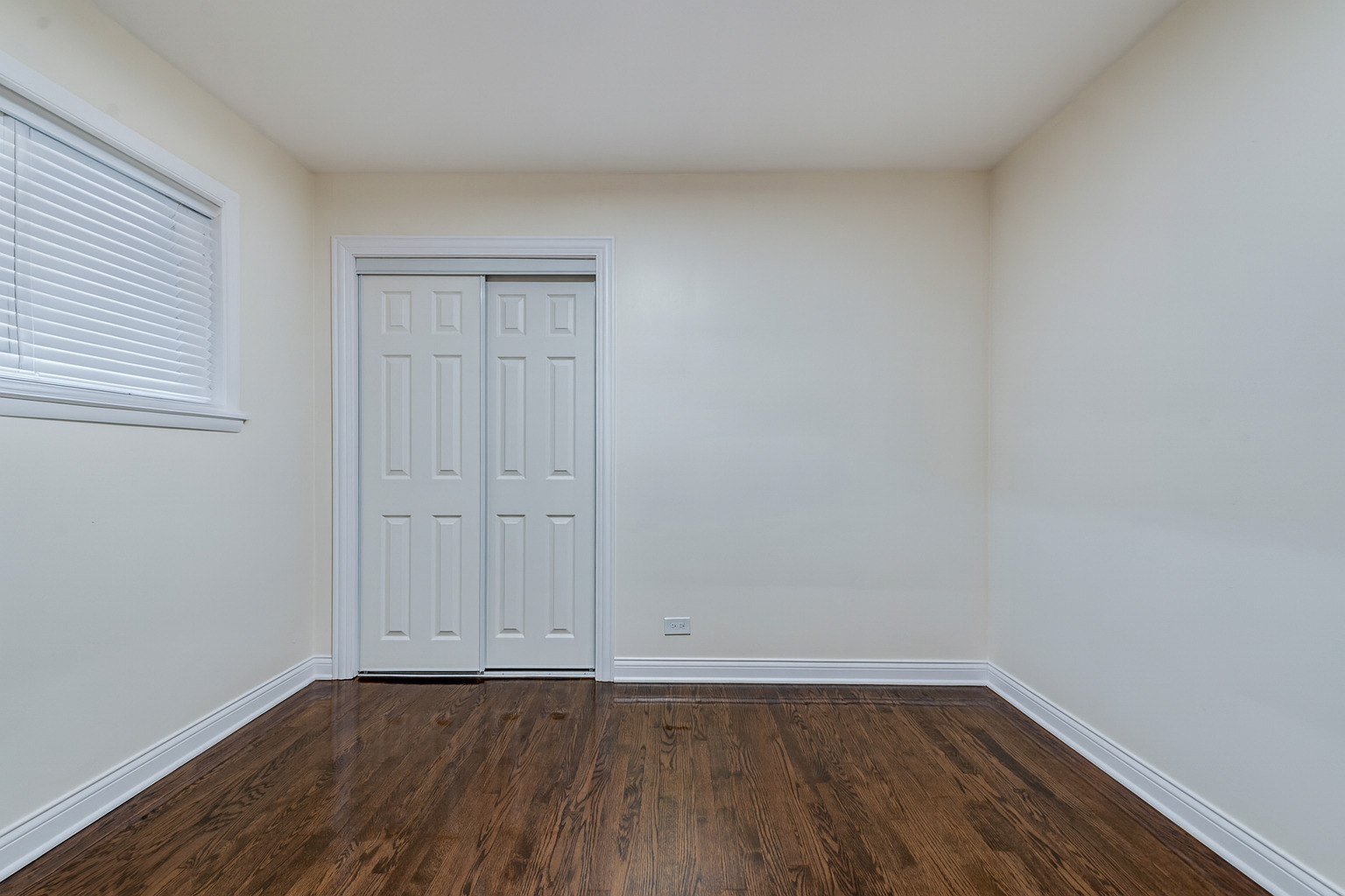1319 East 89th Street Chicago, IL 60619 - Photo 10 of 17 a view of an empty room with wooden floor