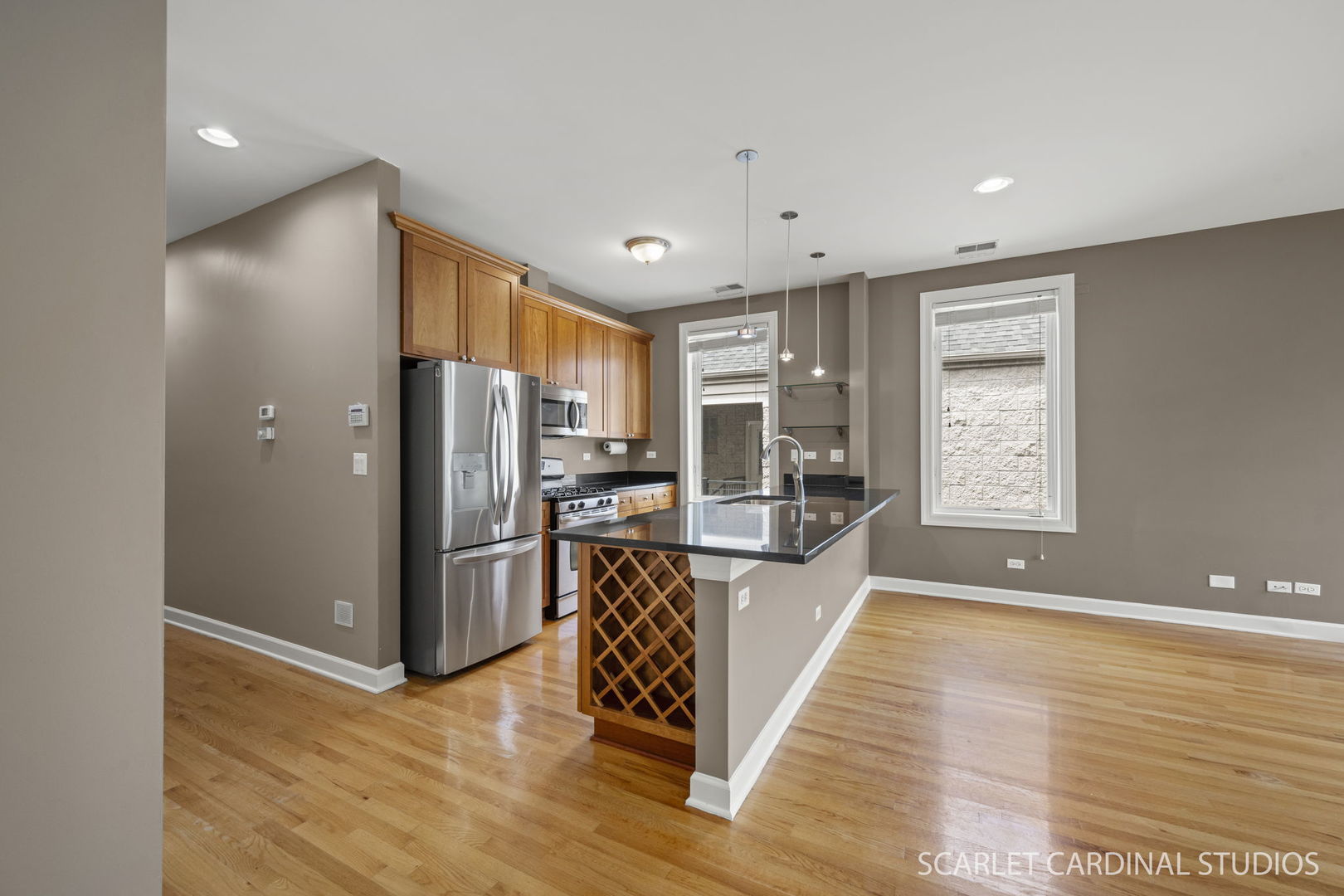 1419 West Fillmore Street, Unit 3W Chicago, IL 60607 - Photo 12 of 26 a view of a kitchen with a refrigerator a window and wooden floor