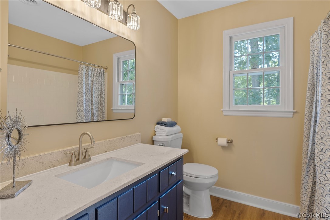 850 Watch Hill Road Midlothian, VA 23114 - Photo 23 of 32 a bathroom with a granite countertop toilet a sink a mirror and a window