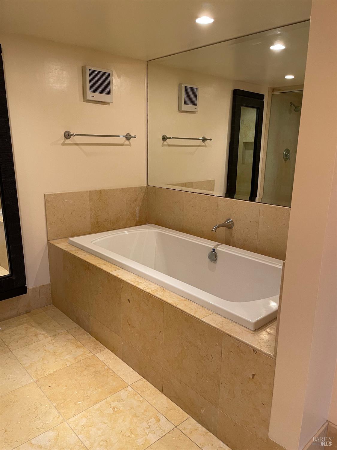 48 Marin Avenue Sausalito, CA 94965 - Photo 16 of 18 a white bath tub sitting in a bathroom