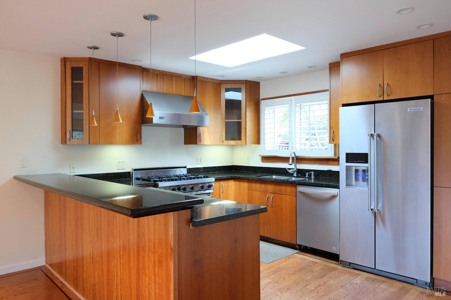 48 Marin Avenue Sausalito, CA 94965 - Photo 5 of 18 a kitchen with stainless steel appliances granite countertop a stove a refrigerator and a sink