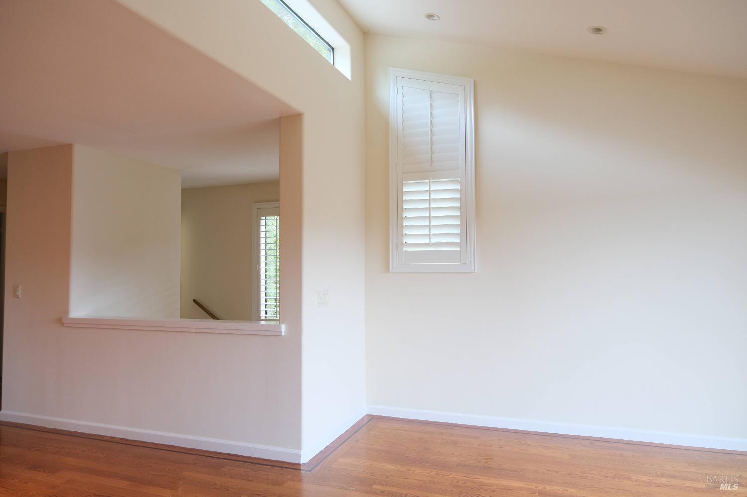 48 Marin Avenue Sausalito, CA 94965 - Photo 8 of 18 an empty room with wooden floor and windows