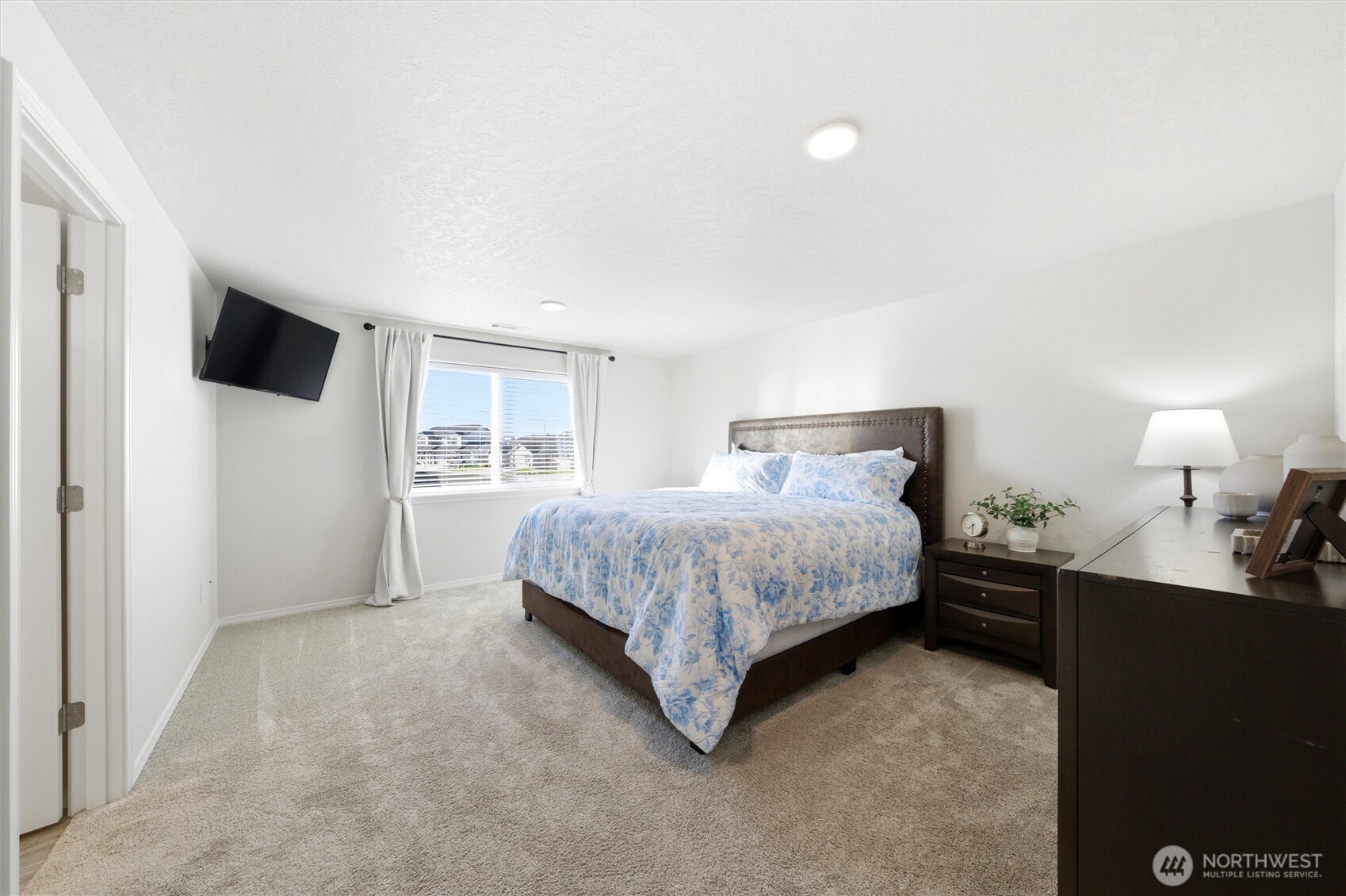 1106 Ava Street Walla Walla, WA 99362 - Photo 14 of 39 a bedroom with a bed and a flat screen tv