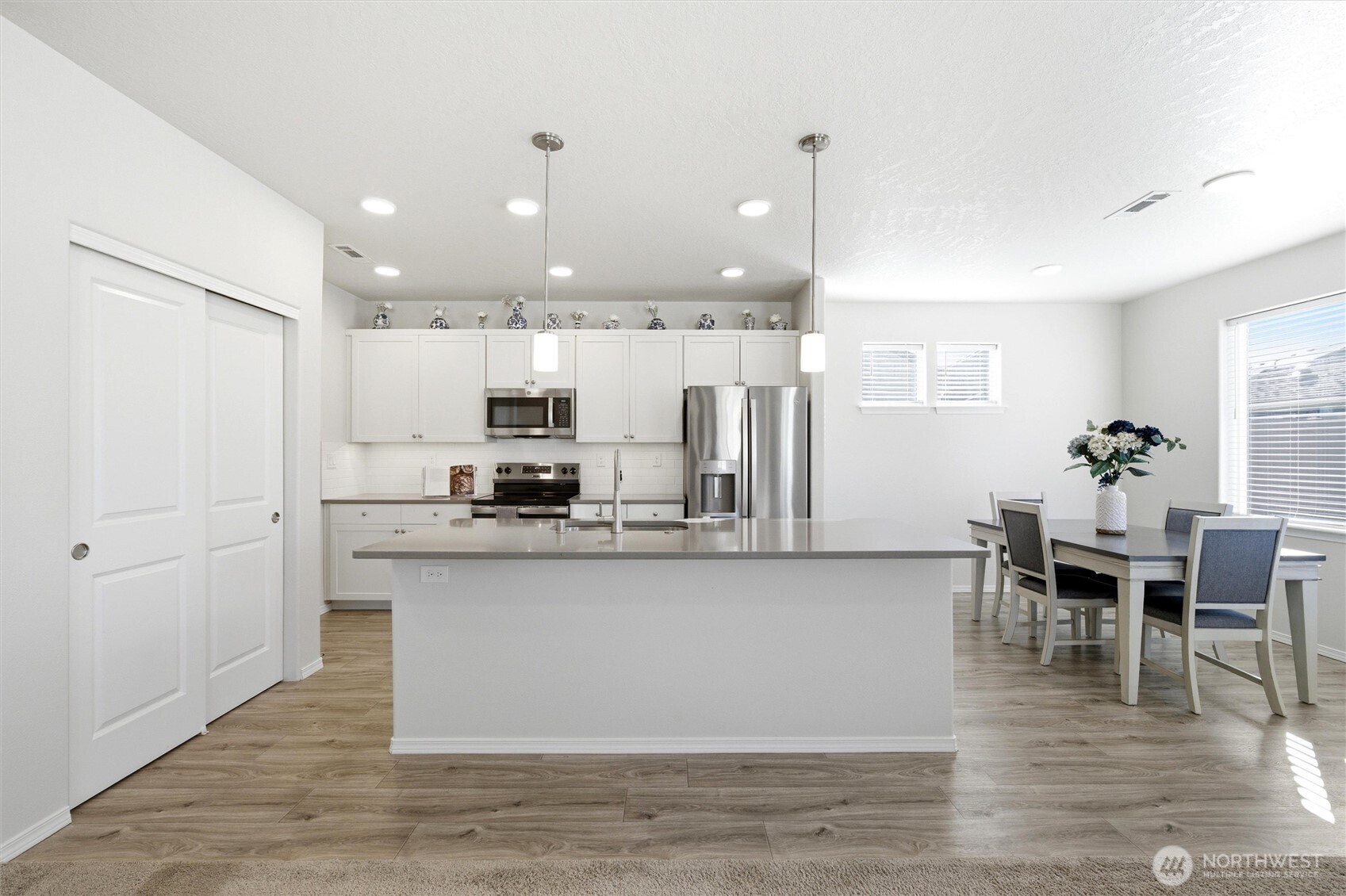 1106 Ava Street Walla Walla, WA 99362 - Photo 5 of 39 a kitchen with stainless steel appliances granite countertop a refrigerator a stove top oven and a dining table with wooden floor