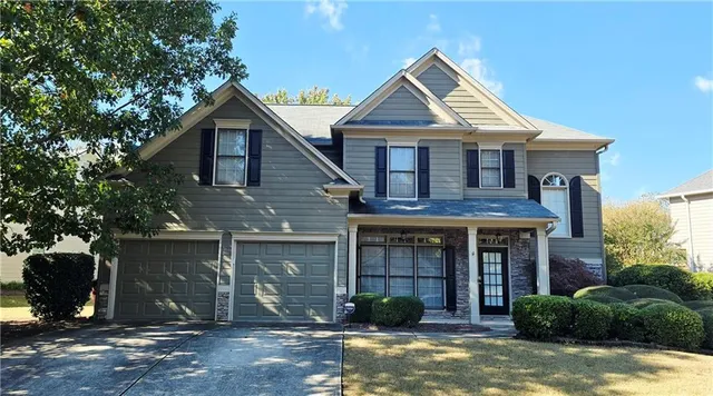 a front view of a house with garden