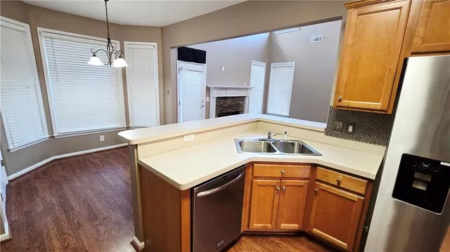 a kitchen with a sink a stove and cabinets