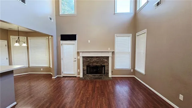 a view of a livingroom with wooden floor and a fireplace