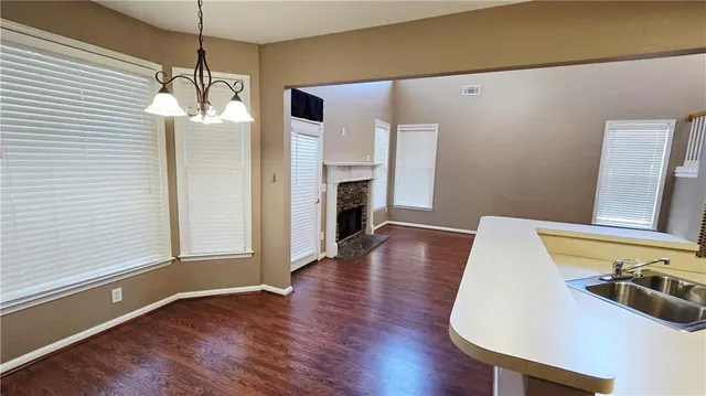a view of a livingroom with wooden floor and a ceiling fan
