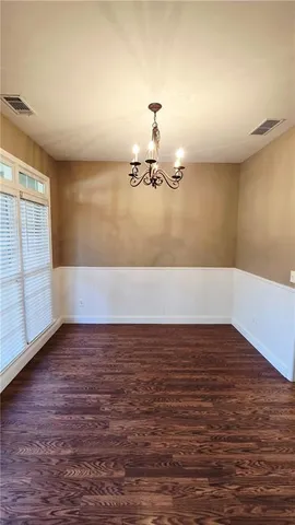 a view of a room with wooden floor