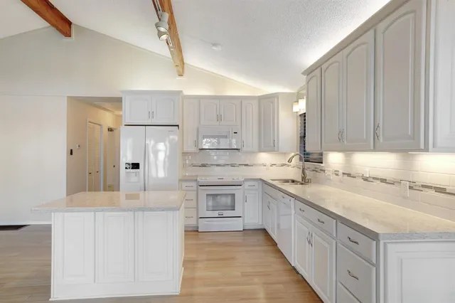a view of a kitchen with furniture and a fireplace