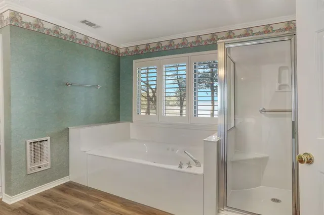 a spacious bathroom with a shower a sink and a mirror