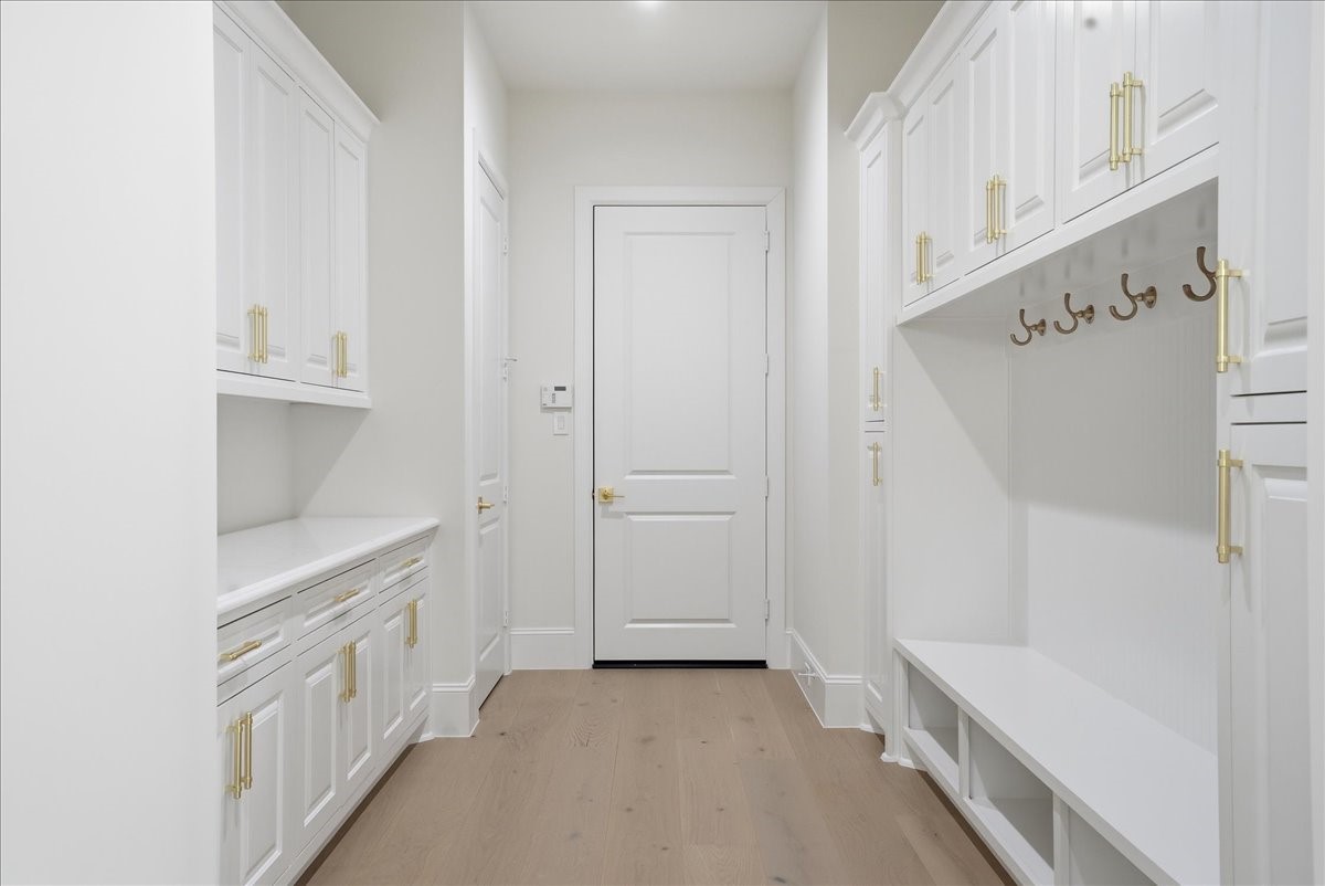 26041 Crown Ranch Boulevard Montgomery, TX 77316 - Photo 29 of 45 The custom mudroom creates an elegant transition from garage to home, with built-in seating, cabinetry, hooks, and workspace designed to keep daily life beautifully organized.