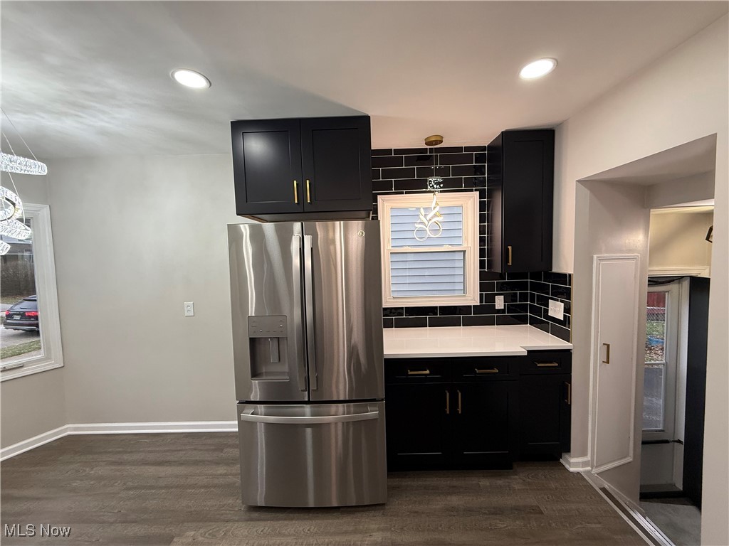 4658 Burleigh Road Cleveland, OH 44125 - Photo 6 of 24 Kitchen with dark cabinets, stainless steel refrigerator with ice dispenser, dark wood-style floors, backsplash, and recessed lighting