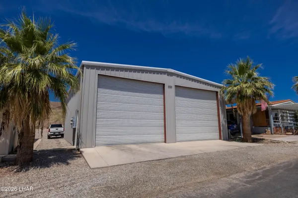 a view of a house with a yard and garage