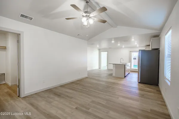 a view of kitchen with refrigerator microwave and wooden floor