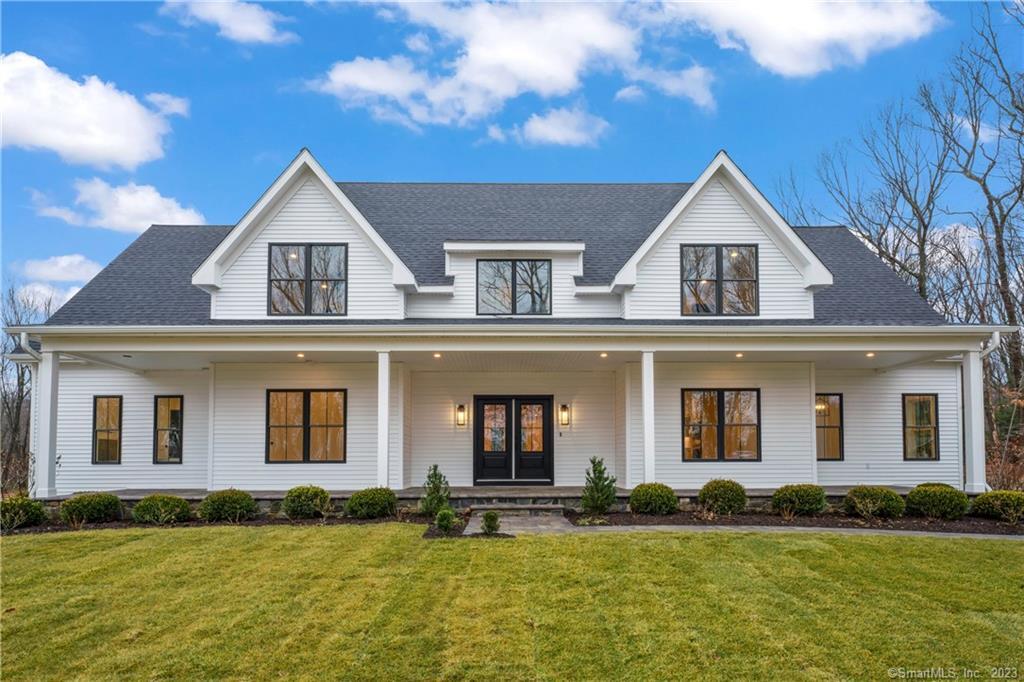 66 Northrop Road Woodbridge, CT 06525 - Photo 1 of 1 a front view of a house with a yard