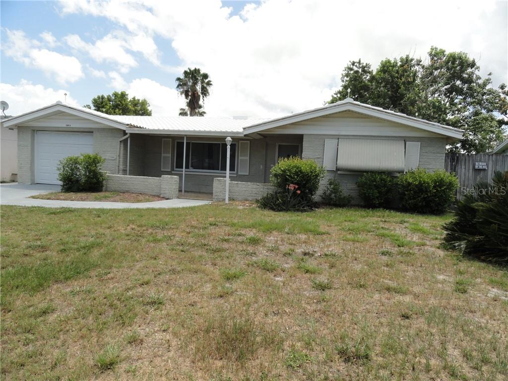 10814 Kingsbridge Road Port Richey, FL 34668 - Photo 1 of 1 a front view of house with yard and green space