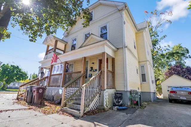 a car parked in front of a white house