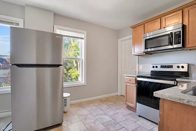 a kitchen with a refrigerator stove and microwave