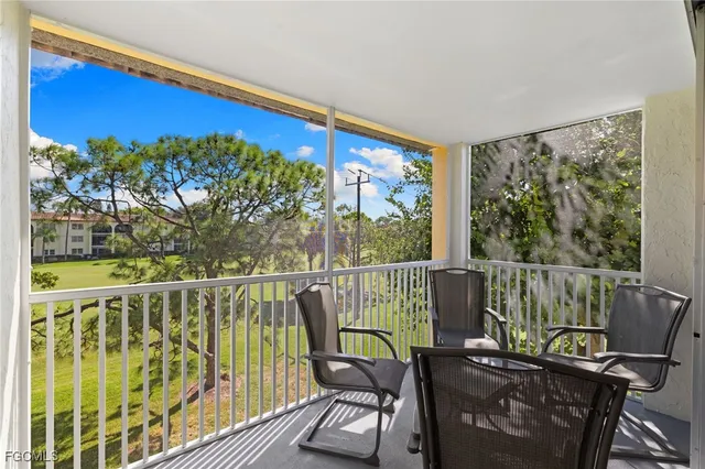 a view of a chair and tables in the balcony
