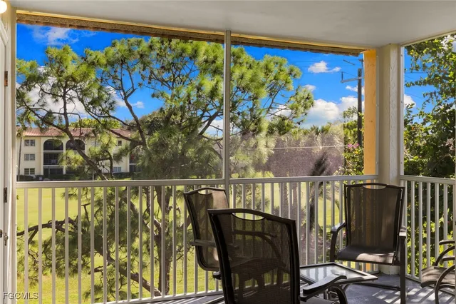 a view of a chairs and table in a balcony