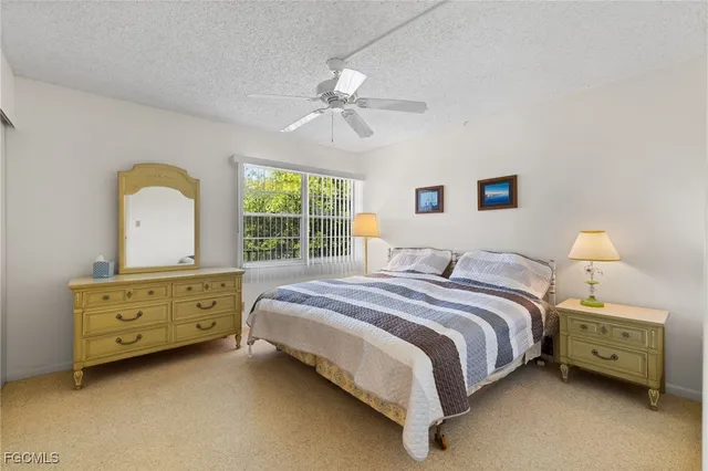 a bedroom with a bed dresser and a window