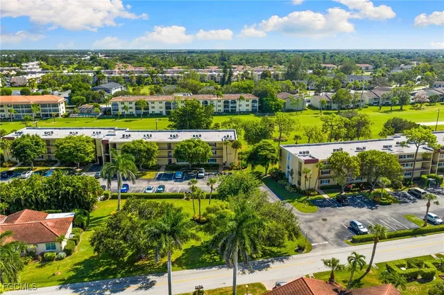 an aerial view of residential houses with outdoor space and street view