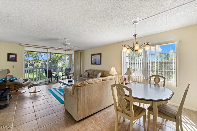 a living room with furniture a window and a table