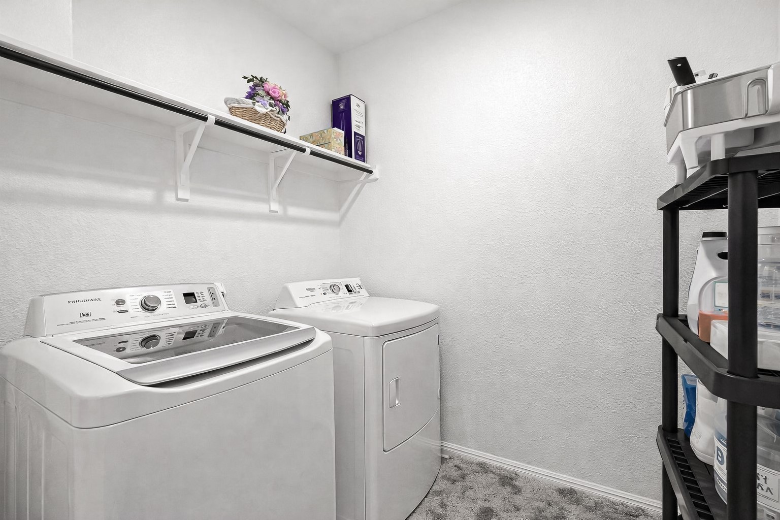 940 Paddock Lane Georgetown, TX 78626 - Photo 18 of 32 Dedicated laundry area featuring a wall-mounted shelving unit and textured wall finishes