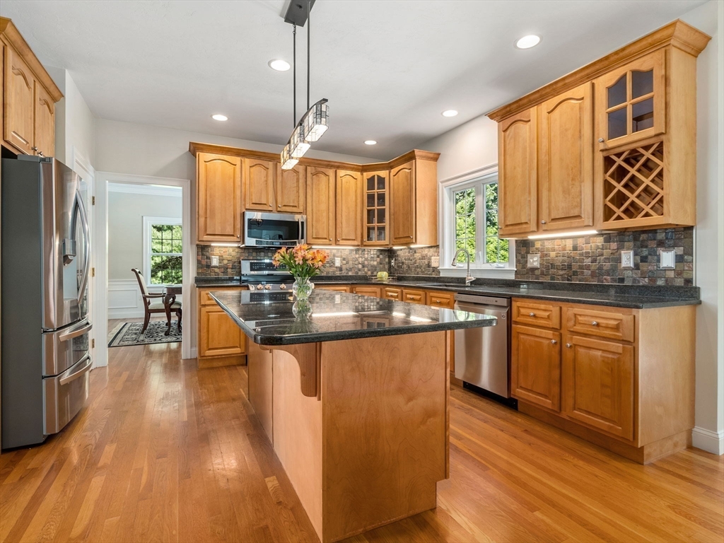 13 Breakneck Hill Road, Unit 1 Hopkinton, MA 01748 - Photo 12 of 37 a kitchen with stainless steel appliances granite countertop a sink stove and refrigerator