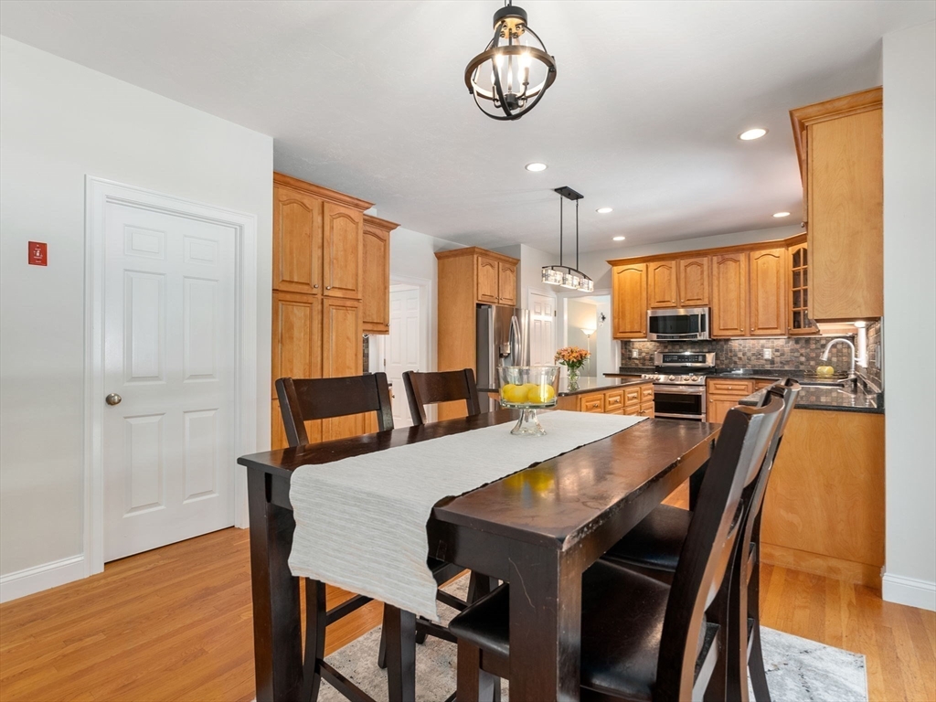 13 Breakneck Hill Road, Unit 1 Hopkinton, MA 01748 - Photo 15 of 37 a view of a dining room with furniture window and wooden floor