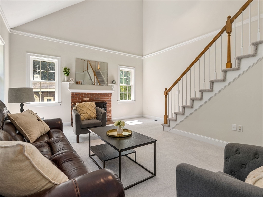13 Breakneck Hill Road, Unit 1 Hopkinton, MA 01748 - Photo 18 of 37 a living room with furniture and a fireplace