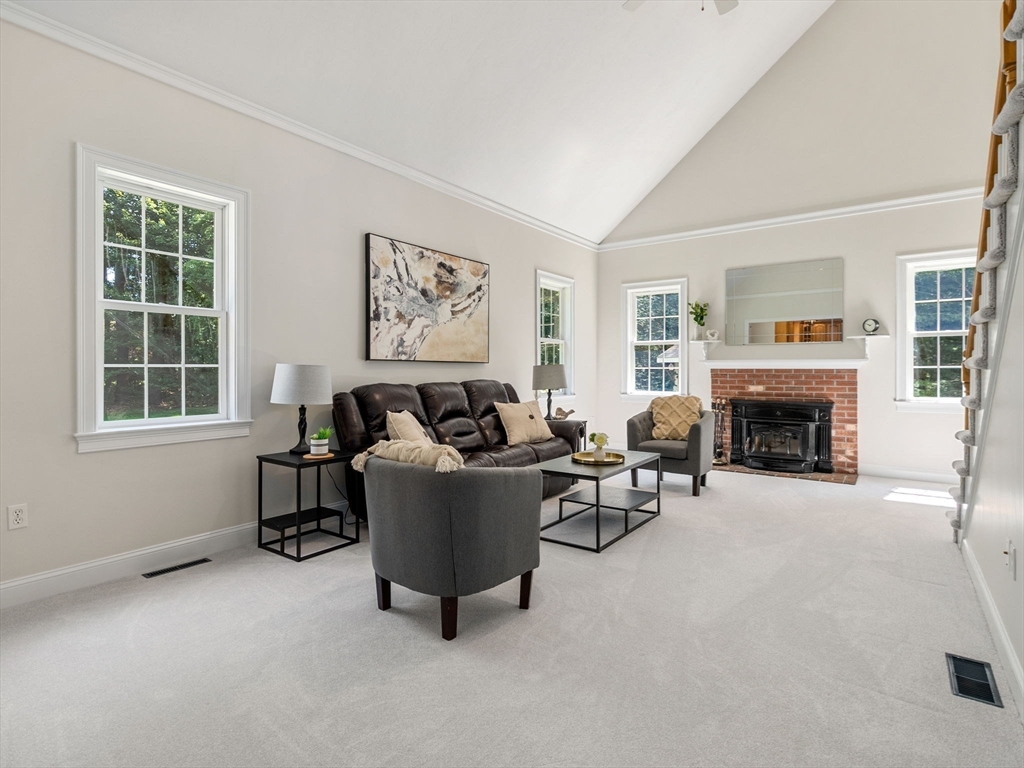 13 Breakneck Hill Road, Unit 1 Hopkinton, MA 01748 - Photo 19 of 37 a living room with furniture and a fireplace