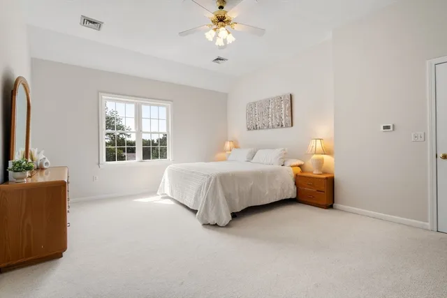 a bedroom with bed couch and window