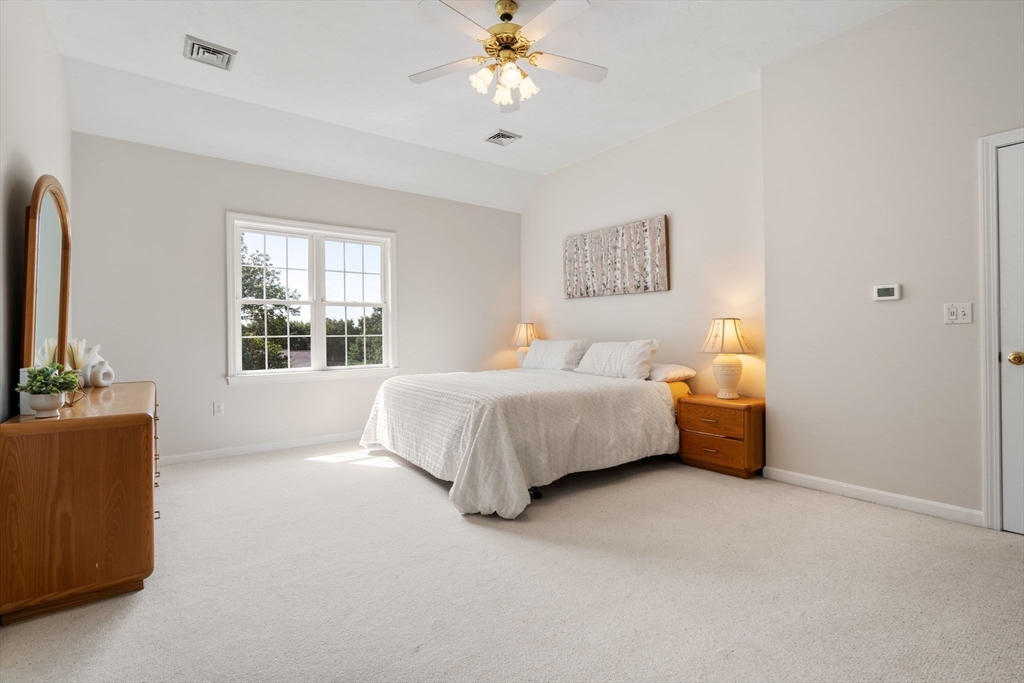 13 Breakneck Hill Road, Unit 1 Hopkinton, MA 01748 - Photo 24 of 37 a bedroom with bed couch and window