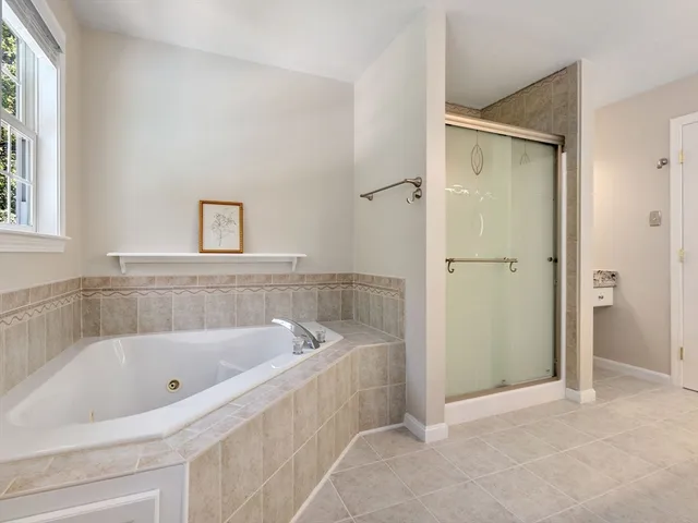 a white bath tub sitting next to a small bathroom