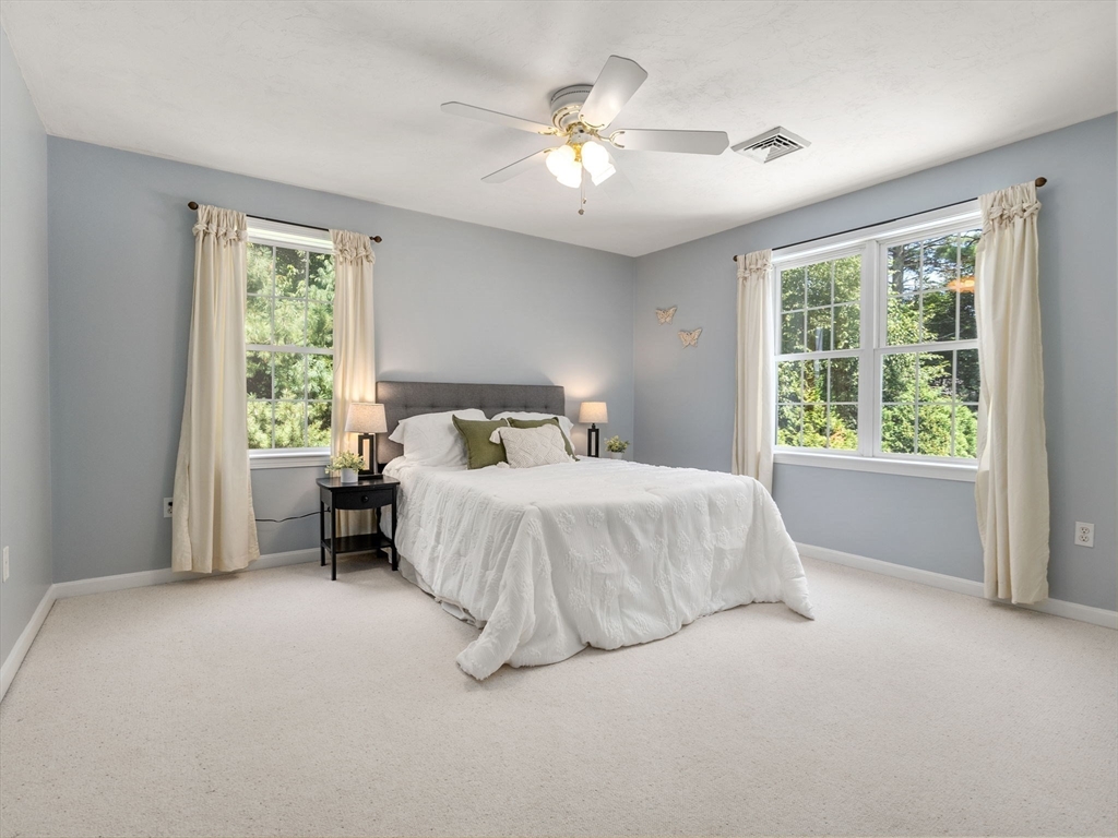 13 Breakneck Hill Road, Unit 1 Hopkinton, MA 01748 - Photo 29 of 37 a spacious bedroom with a bed and a large window