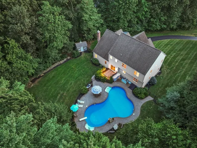 an aerial view of a house with yard swimming pool and outdoor seating