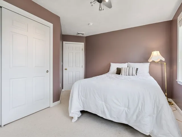 a bedroom with a bed and a night stand