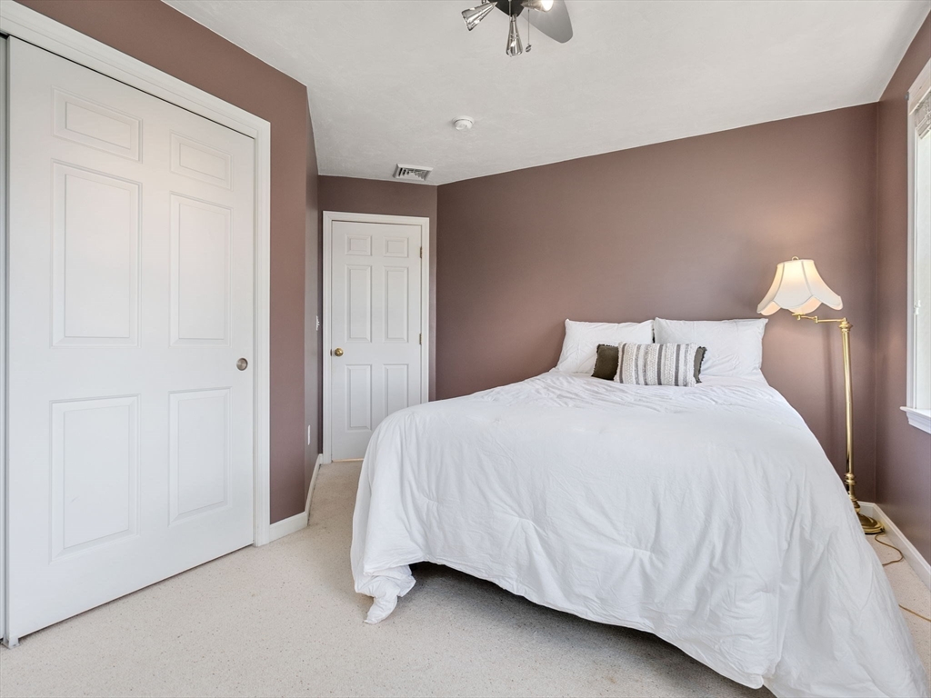 13 Breakneck Hill Road, Unit 1 Hopkinton, MA 01748 - Photo 32 of 37 a bedroom with a bed and a night stand