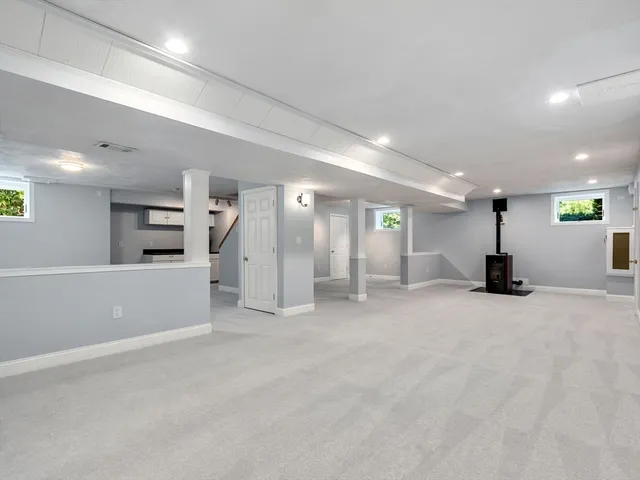 an empty room with a empty space and windows