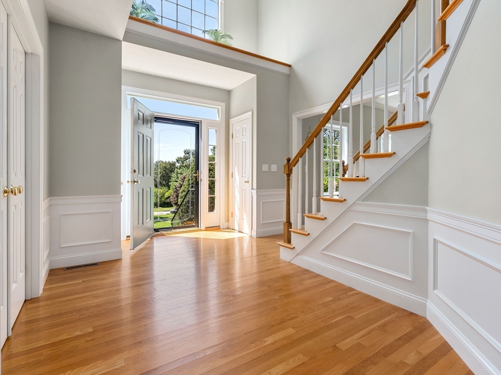 13 Breakneck Hill Road, Unit 1 Hopkinton, MA 01748 - Photo 8 of 37 a view of staircase with white walls and a window
