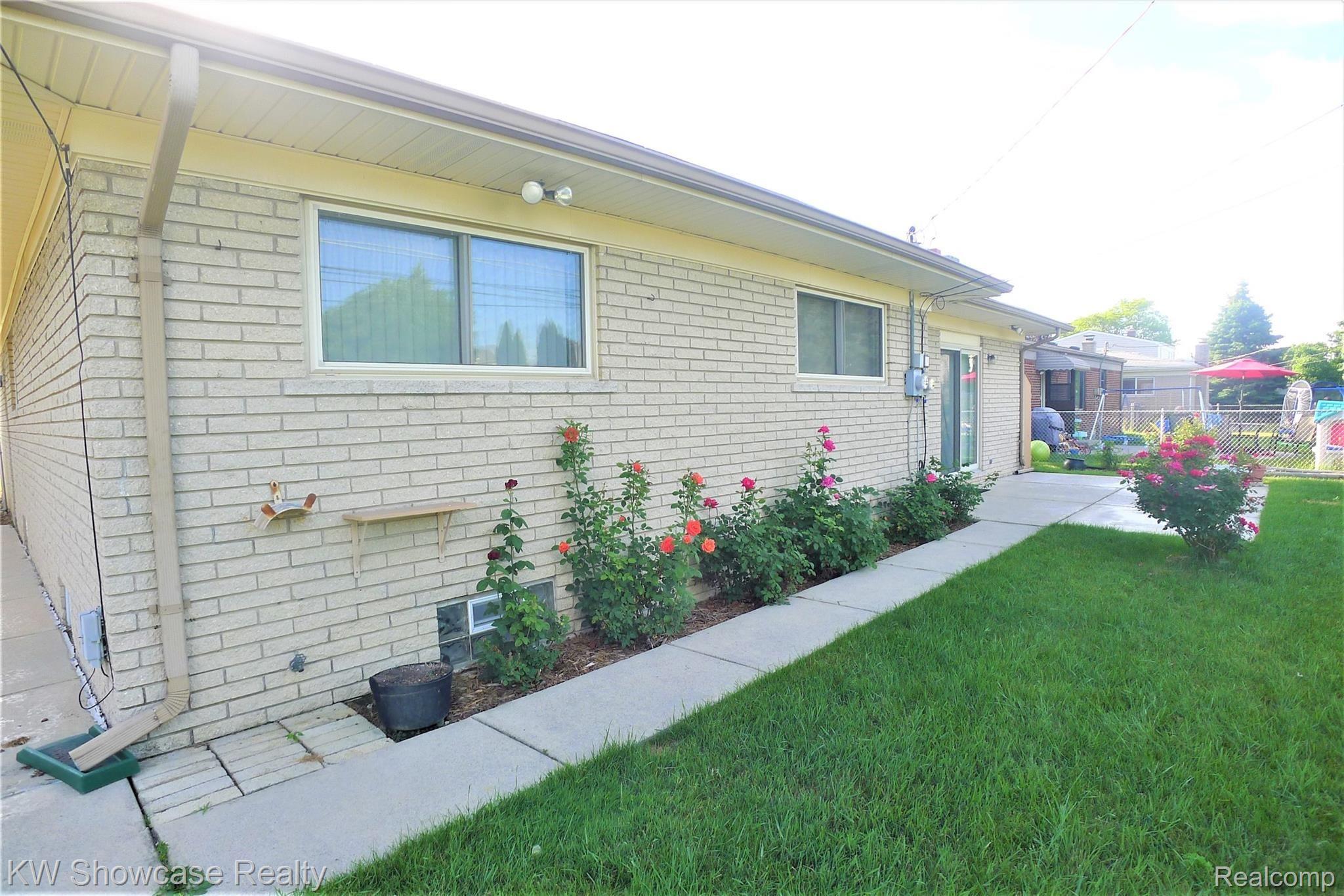 34264 Greentrees Road Sterling Heights, MI 48312 - Photo 36 of 42 Beautiful Rose Bush Sidewalk to Back Yard Patio.