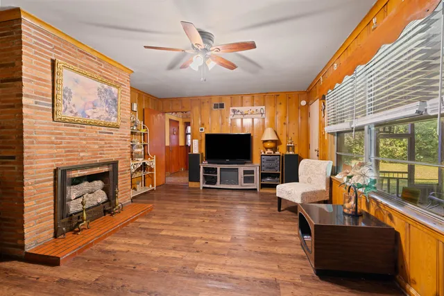 a living room with furniture a flat screen tv and a fireplace