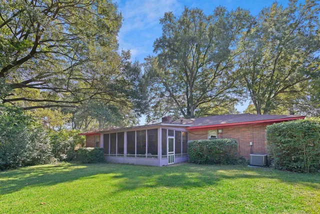 a view of a house with a yard and a garden